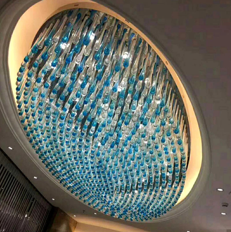 Large oval crystal chandelier with layered blue and clear hanging bead strands