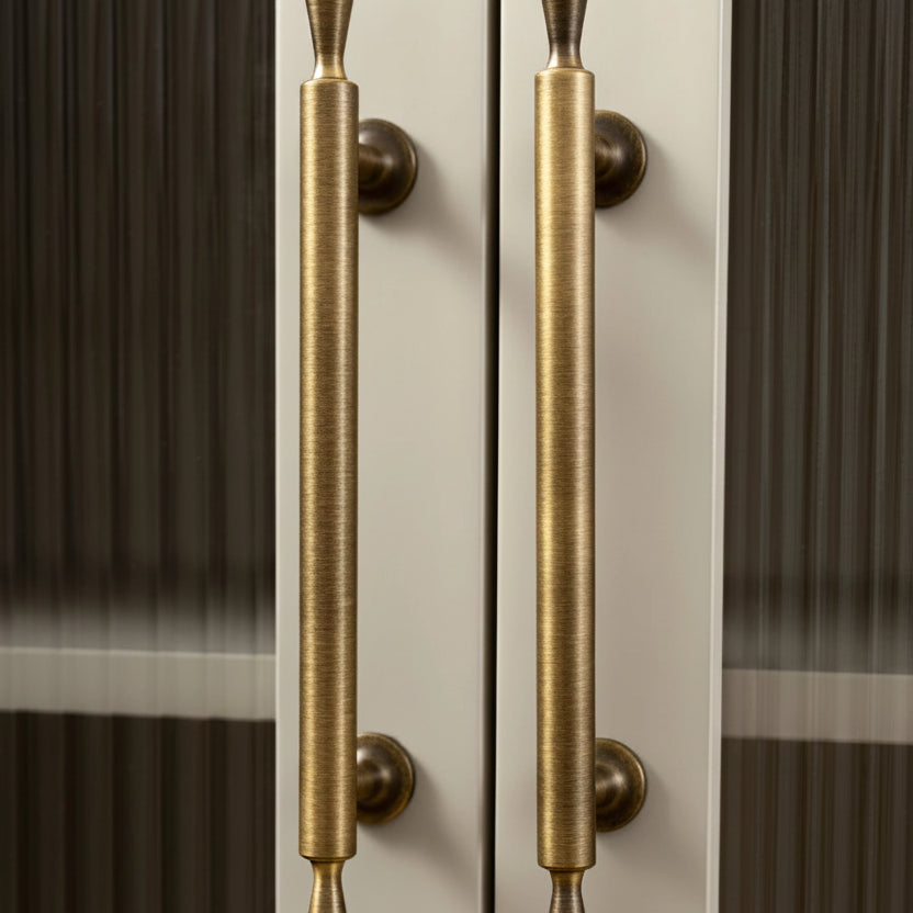 Brass door handles on a glass door with 'Santaya' branding.
