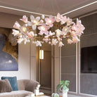 Glowing ceramic flower chandelier with pink-white petals and gold metal frame in a room