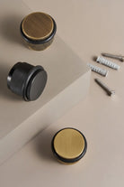 Knurled floor door stop with black body and black ring, plus mounting screws