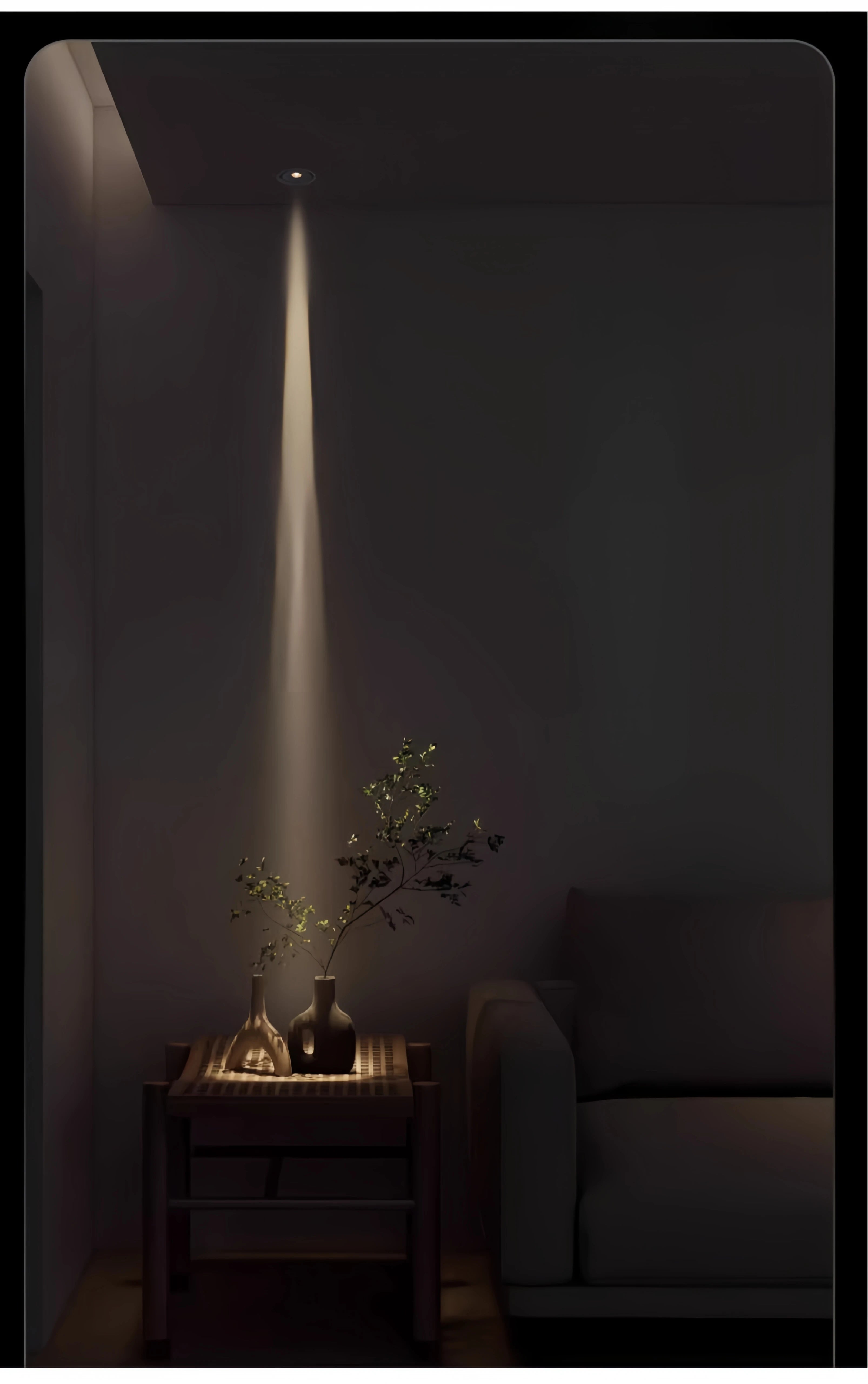 Adjustable LED zoom spotlight casting a narrow warm light beam on a console table plant