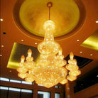 Gold crystal chandelier with glowing center globe and hanging crystal lanterns, multi-tier