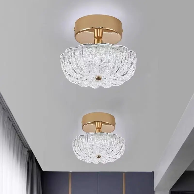 Gold flush-mount ceiling light with clear crystal-style acrylic drum shade