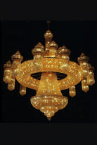 Gold crystal chandelier with tiered ring arms and sparkling strands, central pendant