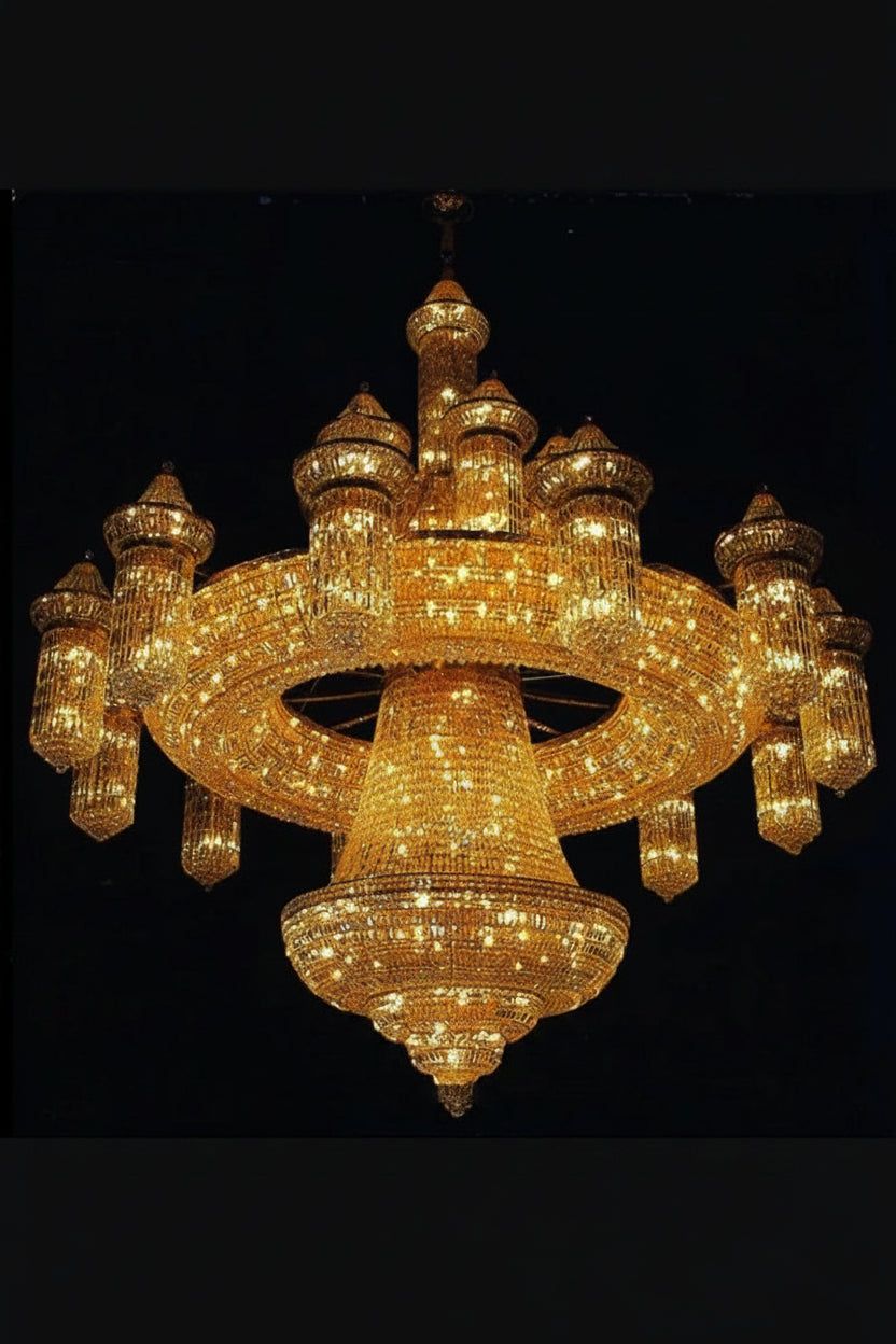 Gold crystal chandelier with tiered ring arms and sparkling strands, central pendant