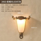Ornate gold wall sconce with frosted glass shade and rose-inspired metal accents