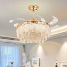 Gold crystal ceiling fan light with clear blades and glowing chandelier-style glass