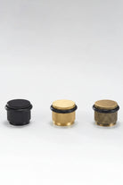 Set of four adjustable knurled floor door stops in black and gold finishes with black rings