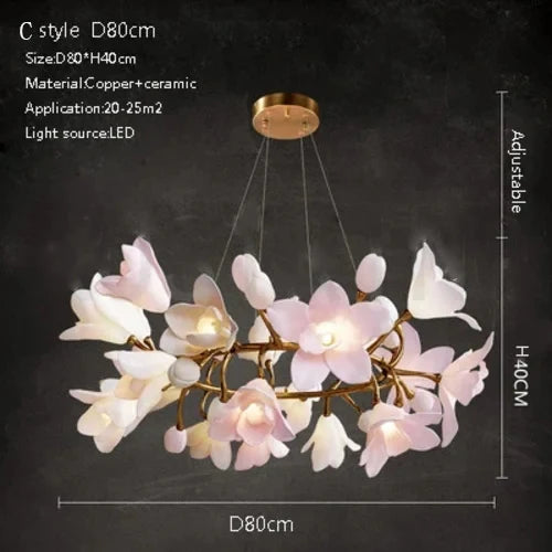Ceramic flower chandelier with glowing white and pink petals and gold metal arm ring