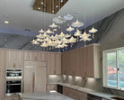 Mushroom ceramic chandelier with many glowing white caps hanging from the ceiling